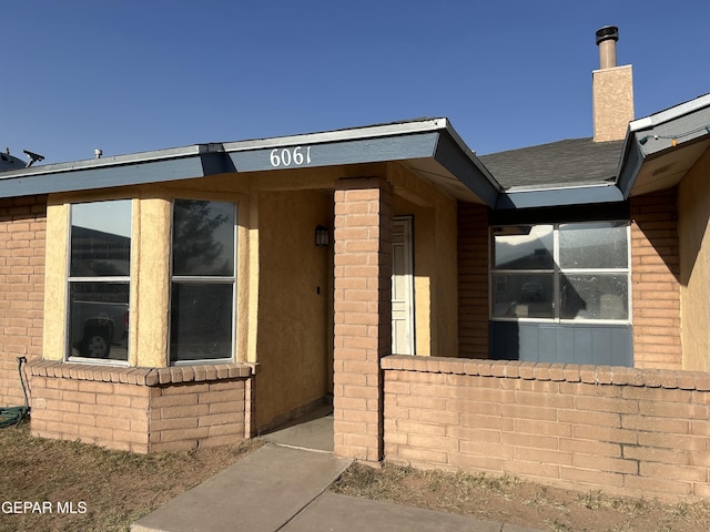 6061 Bridalveil Dr, El Paso, TX 79924 - doorway to property with a chimney and brick siding