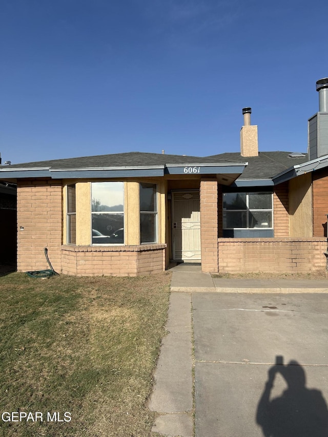 6061 Bridalveil Dr, El Paso, TX 79924 - ranch-style home featuring brick siding, a chimney, and a shingled roof