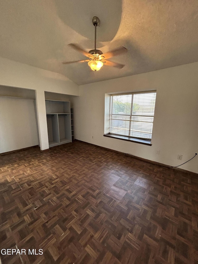 6061 Bridalveil Dr, El Paso, TX 79924 - unfurnished bedroom featuring two closets, baseboards, a ceiling fan, and a textured ceiling