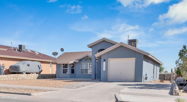 13324 Mitchell Dr, Horizon City, TX 79928 - ranch-style house featuring stucco siding, a garage, driveway, and central AC