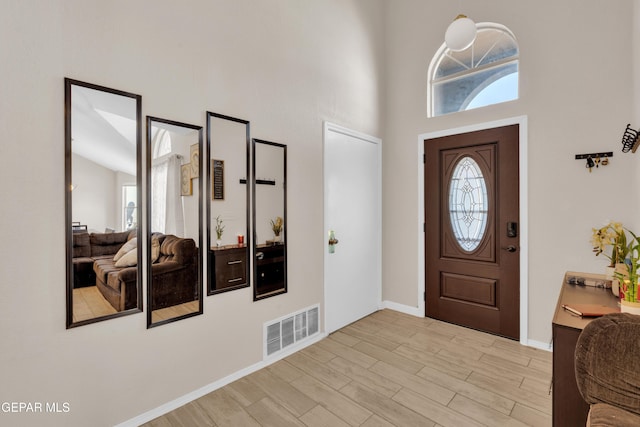 13324 Mitchell Dr, Horizon City, TX 79928 - foyer featuring plenty of natural light, a high ceiling, light wood-type flooring, and baseboards