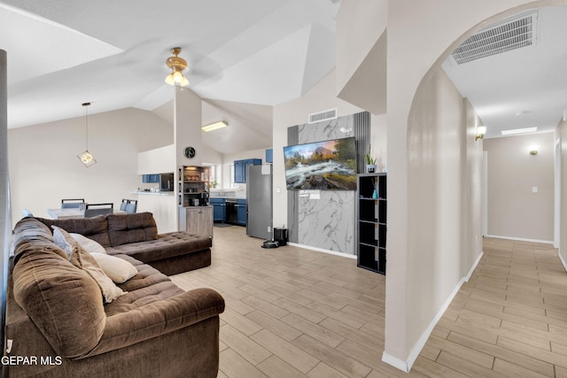 13324 Mitchell Dr, Horizon City, TX 79928 - living room featuring light wood-style floors, ceiling fan, lofted ceiling, and baseboards