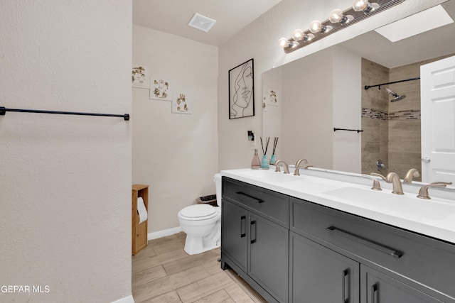 13324 Mitchell Dr, Horizon City, TX 79928 - full bathroom with toilet, double vanity, tiled shower, and baseboards