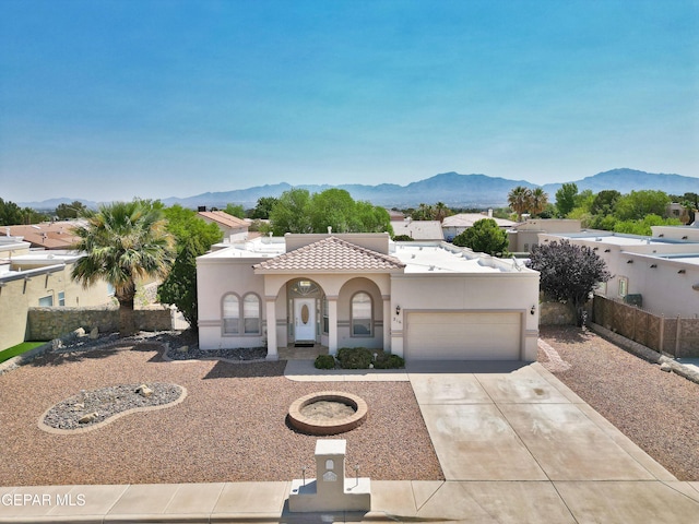 216 Desert Garden Dr, Santa Teresa, NM 88008 - mediterranean / spanish-style house featuring stucco siding, an attached garage, a mountain view, concrete driveway, and a tile roof