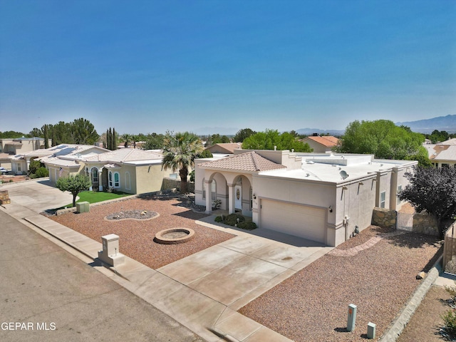 216 Desert Garden Dr, Santa Teresa, NM 88008 - mediterranean / spanish home featuring stucco siding, concrete driveway, an attached garage, and a tile roof