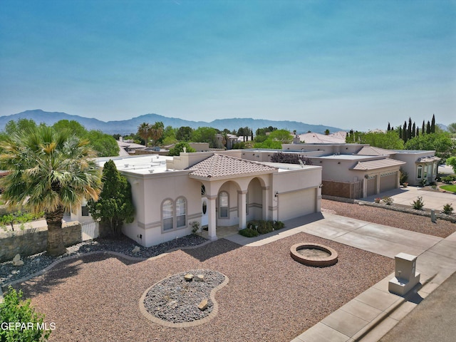 216 Desert Garden Dr, Santa Teresa, NM 88008 - mediterranean / spanish-style home featuring concrete driveway, an attached garage, stucco siding, a mountain view, and a tiled roof