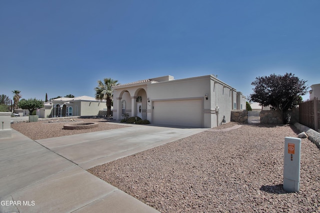 216 Desert Garden Dr, Santa Teresa, NM 88008 - mediterranean / spanish home featuring driveway, an attached garage, and stucco siding