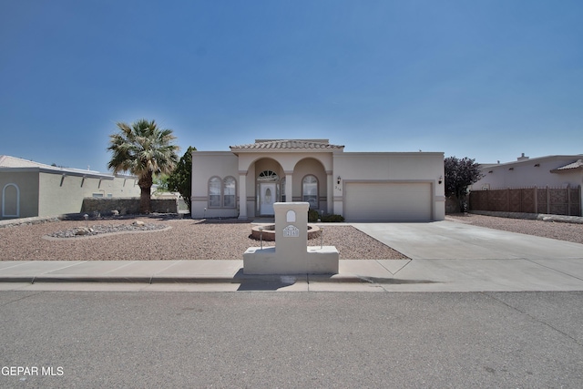 216 Desert Garden Dr, Santa Teresa, NM 88008 - mediterranean / spanish-style home featuring concrete driveway, a garage, and stucco siding