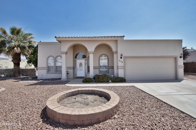 216 Desert Garden Dr, Santa Teresa, NM 88008 - mediterranean / spanish home featuring concrete driveway, a garage, and stucco siding