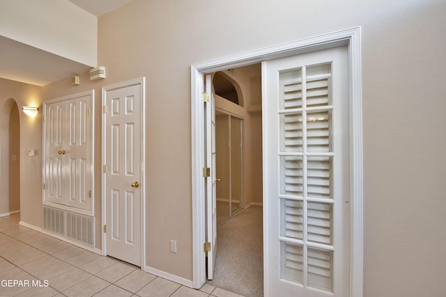 216 Desert Garden Dr, Santa Teresa, NM 88008 - corridor featuring arched walkways, light tile patterned flooring, and baseboards