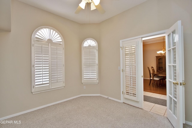 216 Desert Garden Dr, Santa Teresa, NM 88008 - empty room with a ceiling fan, tile patterned floors, carpet, and baseboards