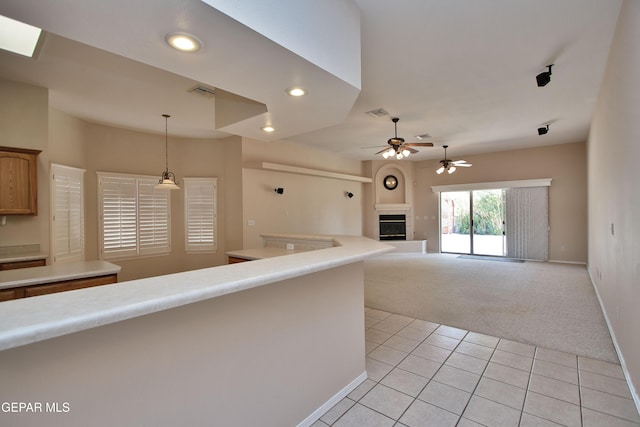216 Desert Garden Dr, Santa Teresa, NM 88008 - unfurnished living room with light carpet, a fireplace, ceiling fan, light tile patterned floors, and recessed lighting