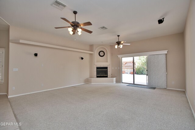 216 Desert Garden Dr, Santa Teresa, NM 88008 - unfurnished living room with a ceiling fan, a tiled fireplace, and light carpet