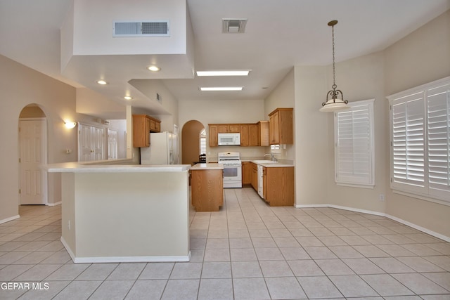 216 Desert Garden Dr, Santa Teresa, NM 88008 - kitchen featuring white appliances, arched walkways, light tile patterned floors, light countertops, and a sink