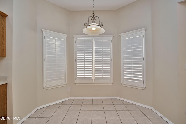 216 Desert Garden Dr, Santa Teresa, NM 88008 - unfurnished dining area with light tile patterned flooring and baseboards