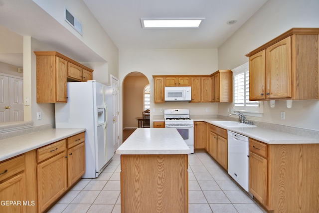 216 Desert Garden Dr, Santa Teresa, NM 88008 - kitchen featuring white appliances, a sink, arched walkways, a kitchen island, and light countertops