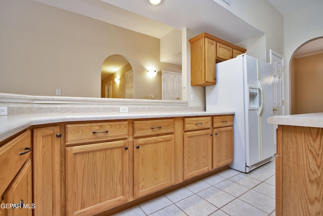 216 Desert Garden Dr, Santa Teresa, NM 88008 - kitchen featuring arched walkways, white refrigerator with ice dispenser, light tile patterned flooring, and light countertops