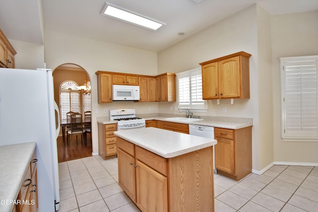 216 Desert Garden Dr, Santa Teresa, NM 88008 - kitchen featuring white appliances, arched walkways, light tile patterned flooring, a sink, and light countertops