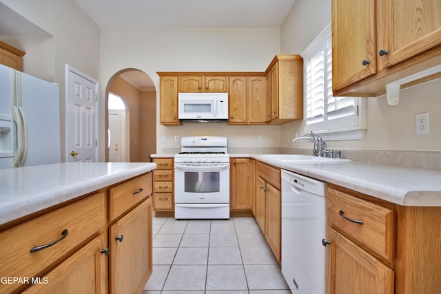 216 Desert Garden Dr, Santa Teresa, NM 88008 - kitchen with white appliances, a sink, arched walkways, light countertops, and light tile patterned floors