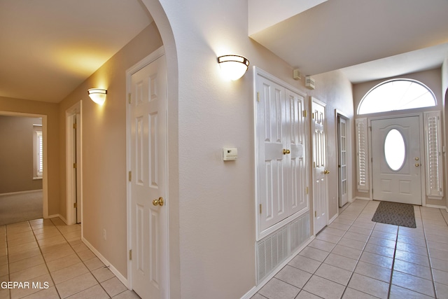 216 Desert Garden Dr, Santa Teresa, NM 88008 - foyer featuring light tile patterned flooring, arched walkways, and baseboards