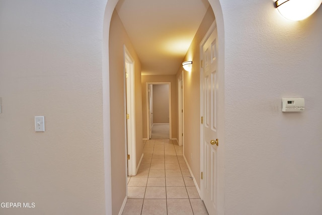 216 Desert Garden Dr, Santa Teresa, NM 88008 - corridor with light tile patterned flooring, baseboards, and arched walkways