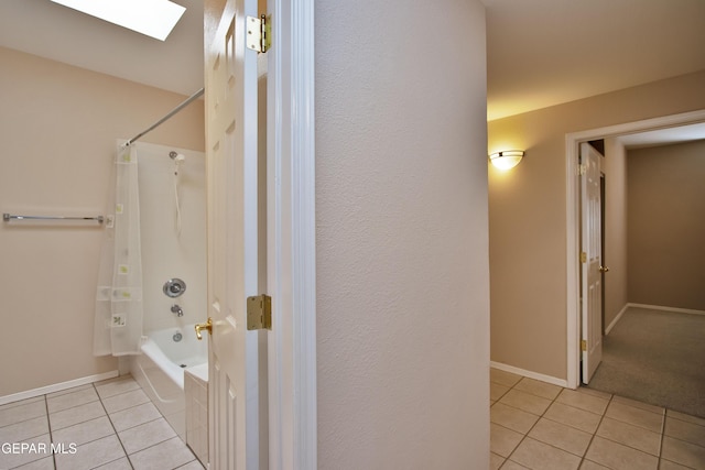 216 Desert Garden Dr, Santa Teresa, NM 88008 - bathroom with tile patterned flooring, bathing tub / shower combination, a skylight, and baseboards