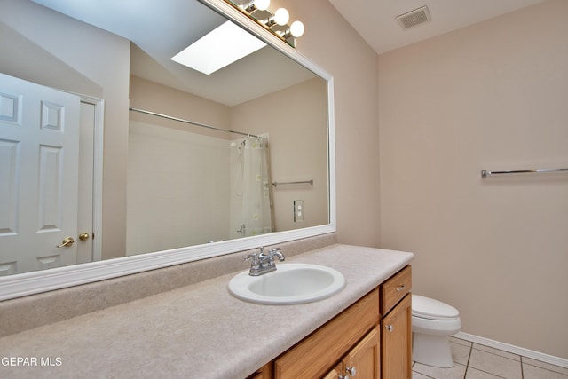 216 Desert Garden Dr, Santa Teresa, NM 88008 - bathroom with tile patterned flooring, vanity, toilet, a skylight, and a shower with shower curtain