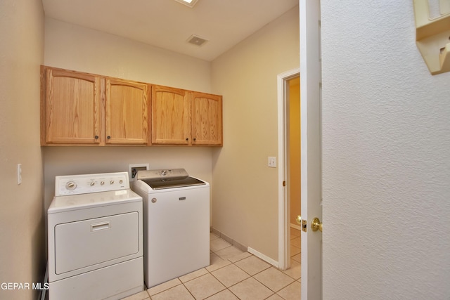 216 Desert Garden Dr, Santa Teresa, NM 88008 - laundry room featuring separate washer and dryer, cabinet space, and light tile patterned floors