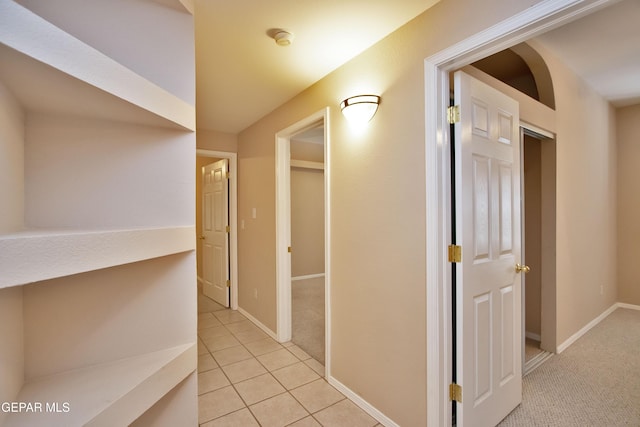 216 Desert Garden Dr, Santa Teresa, NM 88008 - corridor with light tile patterned floors, baseboards, and light carpet