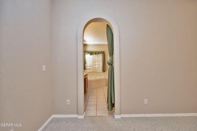 216 Desert Garden Dr, Santa Teresa, NM 88008 - hall with light carpet, baseboards, and arched walkways