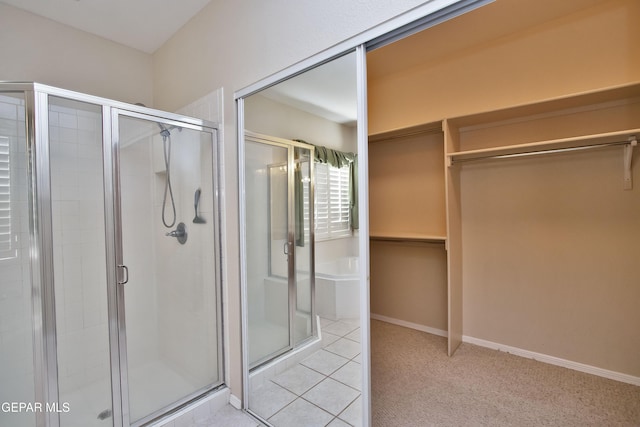 216 Desert Garden Dr, Santa Teresa, NM 88008 - bathroom featuring a stall shower, a walk in closet, and tile patterned floors