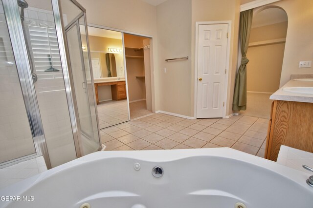 216 Desert Garden Dr, Santa Teresa, NM 88008 - full bathroom featuring double vanity, tile patterned flooring, a tub with jets, a shower stall, and a spacious closet