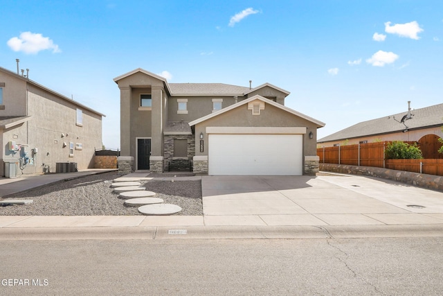 11562 Flor Gloriosa Dr, Socorro, TX 79927 - view of front of home featuring stone siding, stucco siding, central AC, and driveway