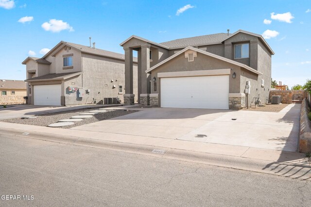 11562 Flor Gloriosa Dr, Socorro, TX 79927 - view of front of property featuring stone siding, concrete driveway, stucco siding, and central air condition unit