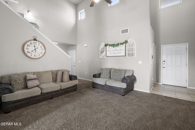 11562 Flor Gloriosa Dr, Socorro, TX 79927 - living area with a high ceiling, light colored carpet, a ceiling fan, baseboards, and light tile patterned flooring