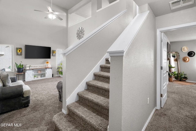 11562 Flor Gloriosa Dr, Socorro, TX 79927 - stairs with carpet floors, a ceiling fan, a high ceiling, baseboards, and a textured wall