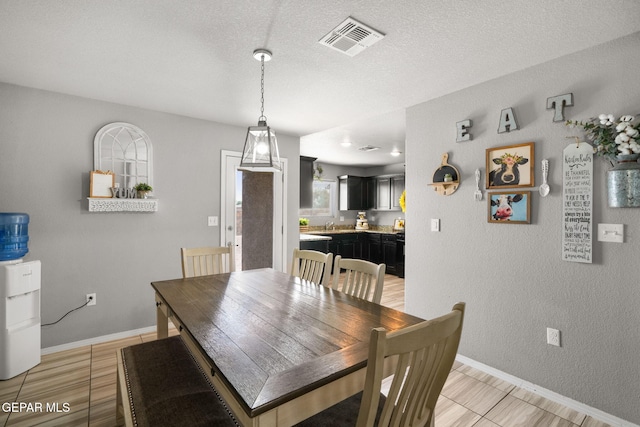 11562 Flor Gloriosa Dr, Socorro, TX 79927 - dining room with baseboards and a textured wall