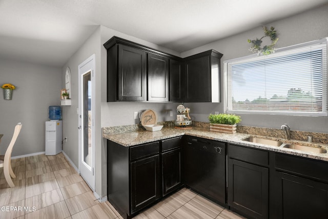 11562 Flor Gloriosa Dr, Socorro, TX 79927 - kitchen featuring dishwasher, a sink, dark cabinets, and light stone counters