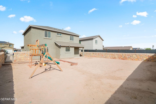11562 Flor Gloriosa Dr, Socorro, TX 79927 - rear view of property with a playground, stucco siding, and a fenced backyard