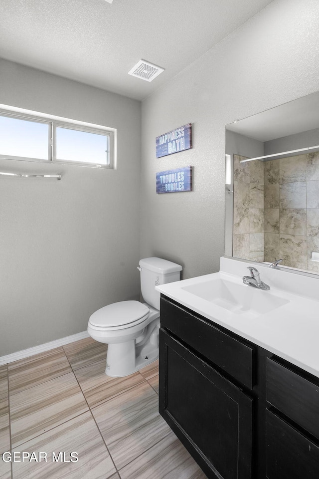 11562 Flor Gloriosa Dr, Socorro, TX 79927 - bathroom with vanity, toilet, a shower, tile patterned floors, and a textured ceiling