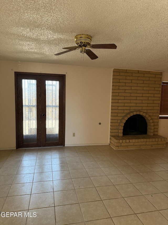 3910 Quasar Ct, El Paso, TX 79904 - unfurnished living room featuring a textured ceiling, french doors, a brick fireplace, light tile patterned floors, and ceiling fan