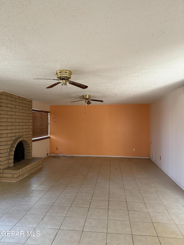 3910 Quasar Ct, El Paso, TX 79904 - unfurnished living room featuring a textured ceiling, ceiling fan, light tile patterned flooring, and a fireplace