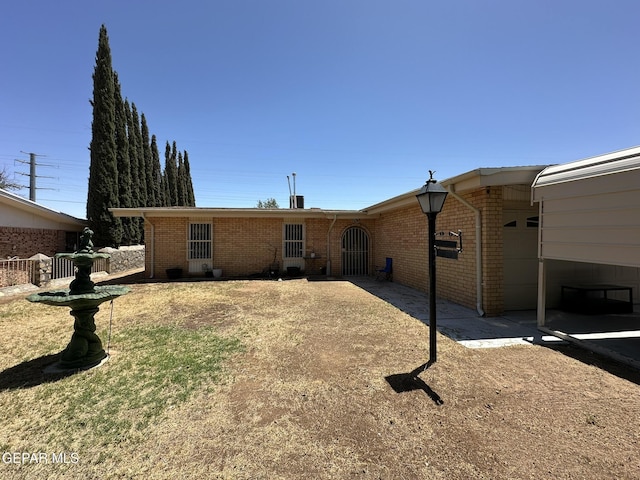 5028 Sagittarius Ave, El Paso, TX 79924 - back of property featuring brick siding and a garage