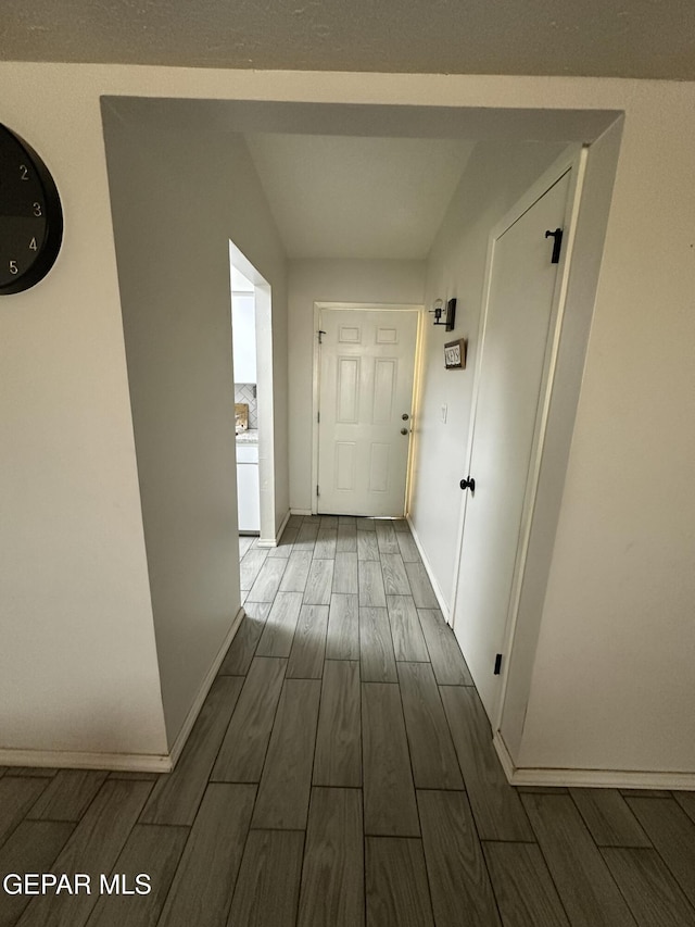5028 Sagittarius Ave, El Paso, TX 79924 - hall featuring dark wood finished floors and baseboards
