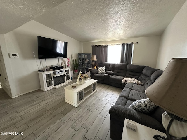 5028 Sagittarius Ave, El Paso, TX 79924 - living area with a textured ceiling, wood finished floors, and baseboards