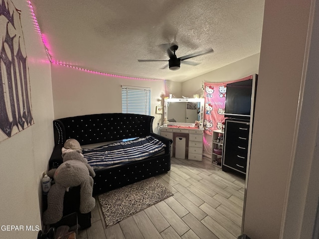 5028 Sagittarius Ave, El Paso, TX 79924 - bedroom with a textured ceiling, light wood finished floors, and a ceiling fan