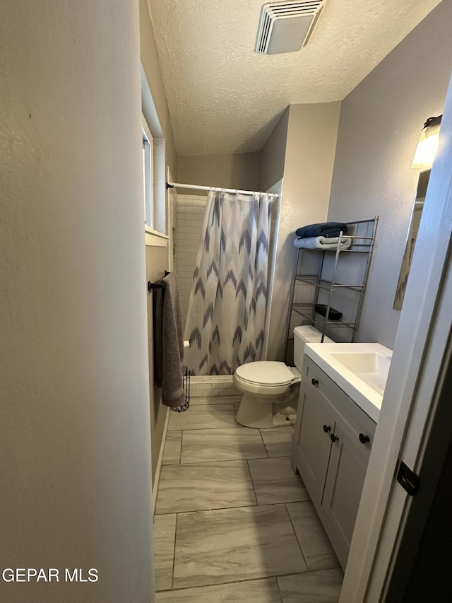 5028 Sagittarius Ave, El Paso, TX 79924 - full bath featuring vanity, toilet, and a textured ceiling
