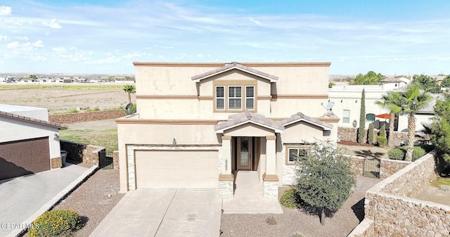 6065 Via De Los Arboles, El Paso, TX 79932 - view of front of home featuring driveway, stucco siding, and an attached garage