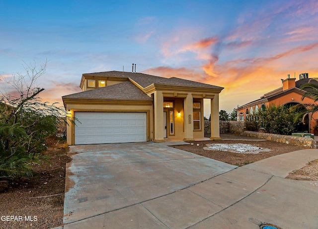 5965 Katelyn Gray Cir, El Paso, TX 79924 - view of front facade with an attached garage, driveway, stucco siding, roof with shingles, and covered porch
