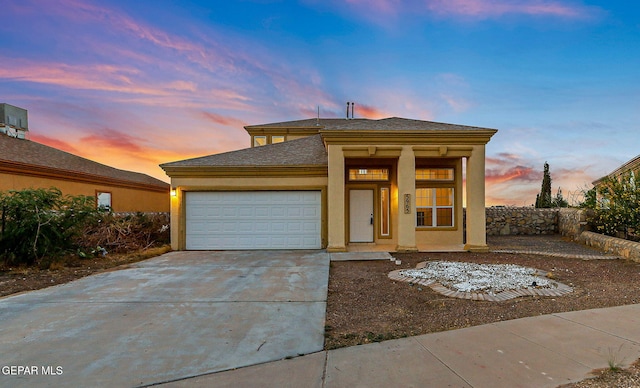 5965 Katelyn Gray Cir, El Paso, TX 79924 - view of front of property featuring an attached garage, concrete driveway, stucco siding, and a shingled roof
